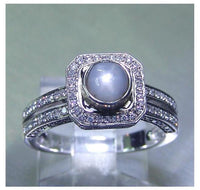 Ladies 14kt. white gold Ceylon intense grey blue star sapphire and diamond halo ring