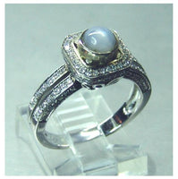 Ladies 14kt. white gold Ceylon intense grey blue star sapphire and diamond halo ring